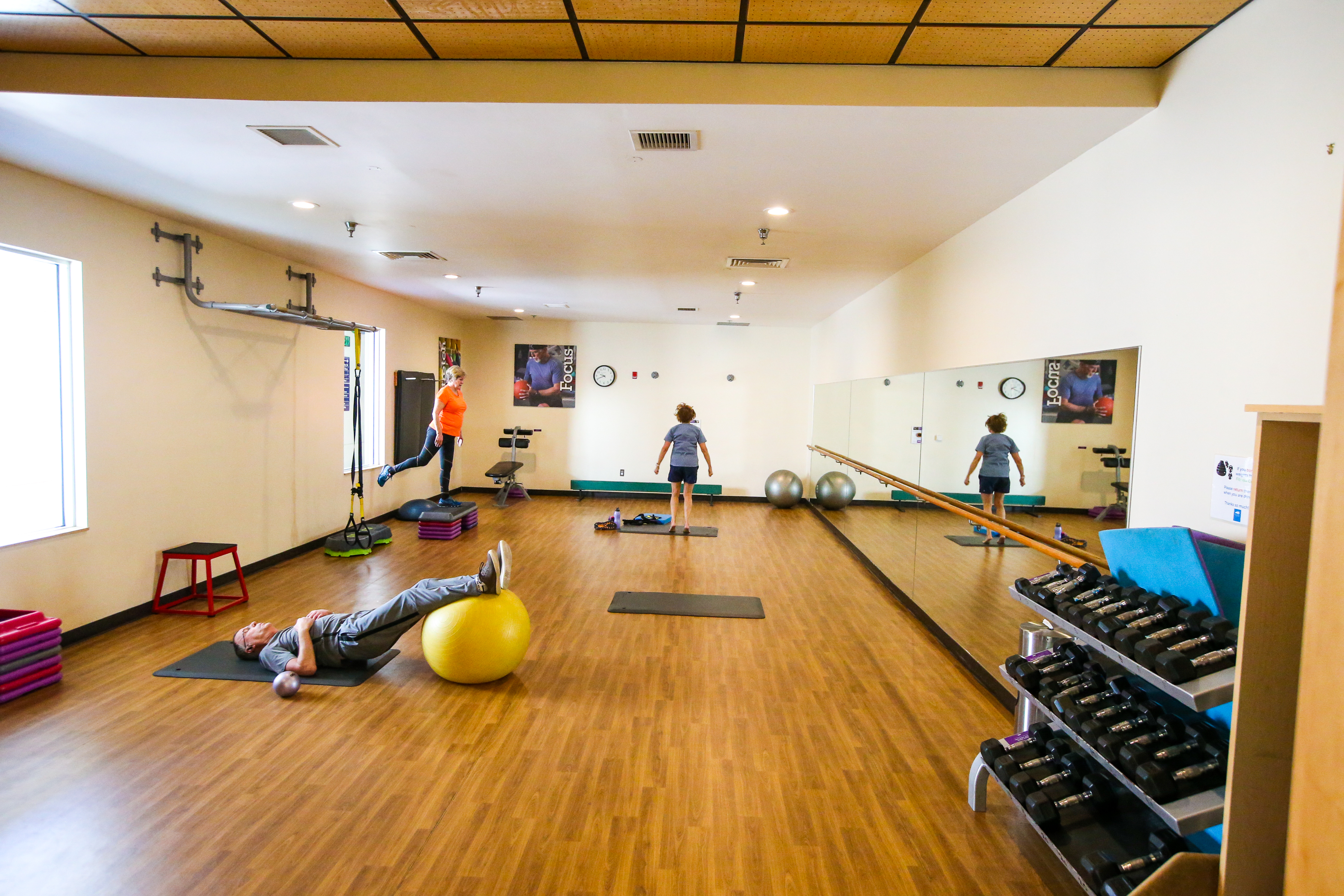 Three patrons doing fitness in the studio at Juniper