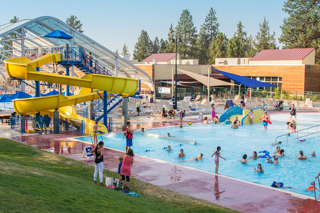 Wide shot of the water slide and activity pool on a sunny day.