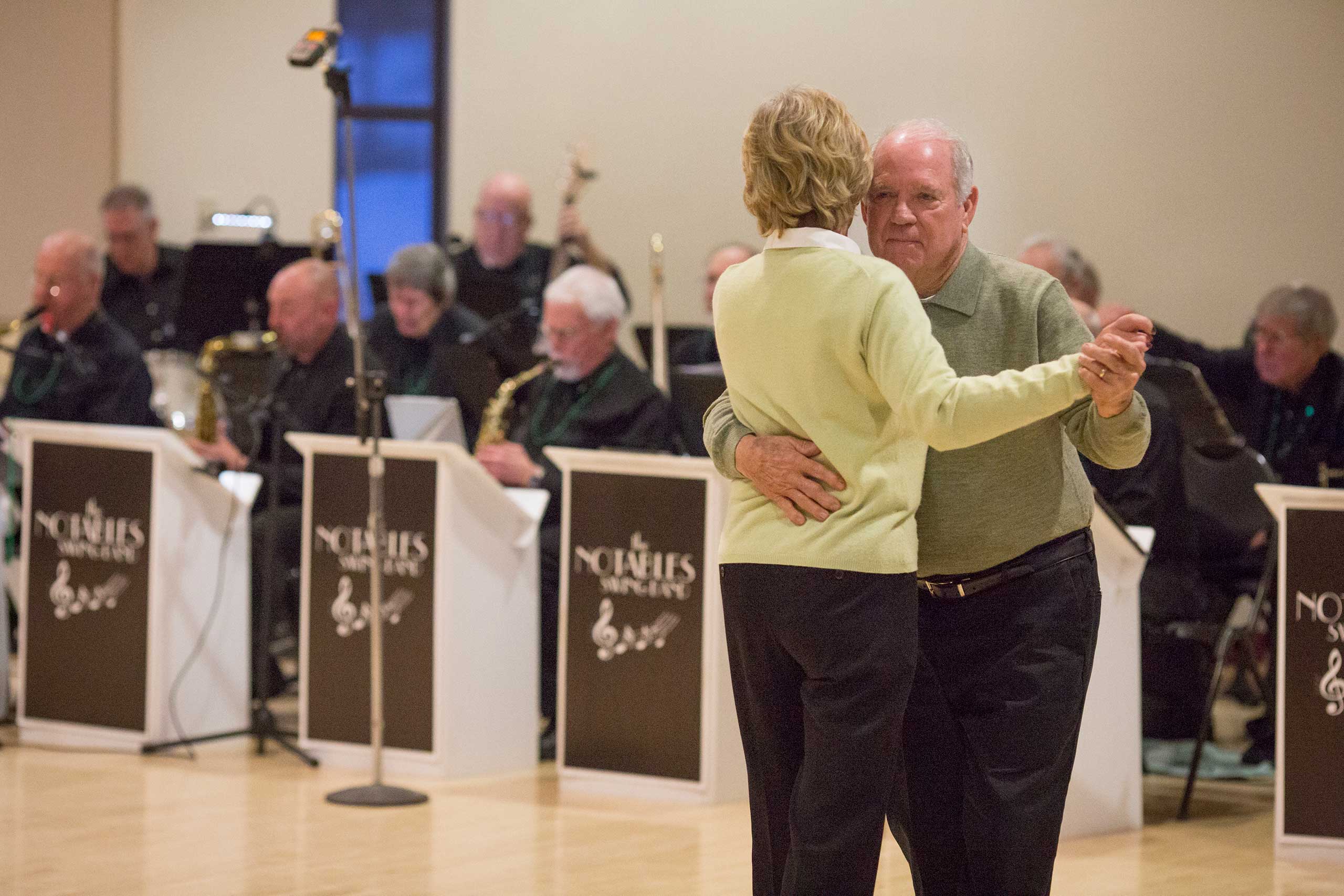 Photo of a couple dancing infront of a band at the St. Patrick's Day Dance