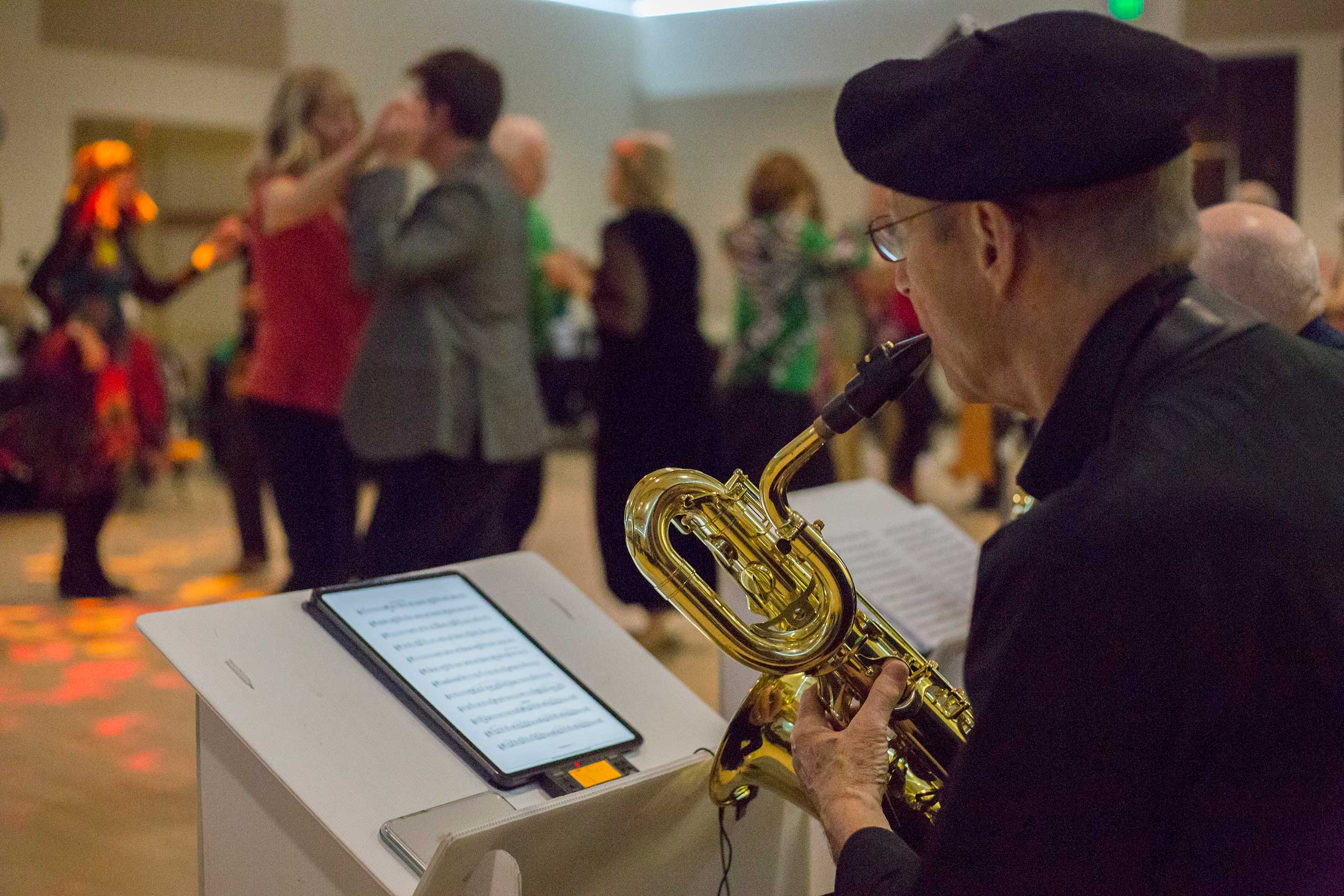 Photo of a musician and dancers at a St. Patrick's Day Dance