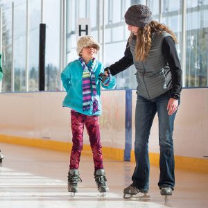 Image of a family skating at a public open skate session at The Pavilion in Bend.