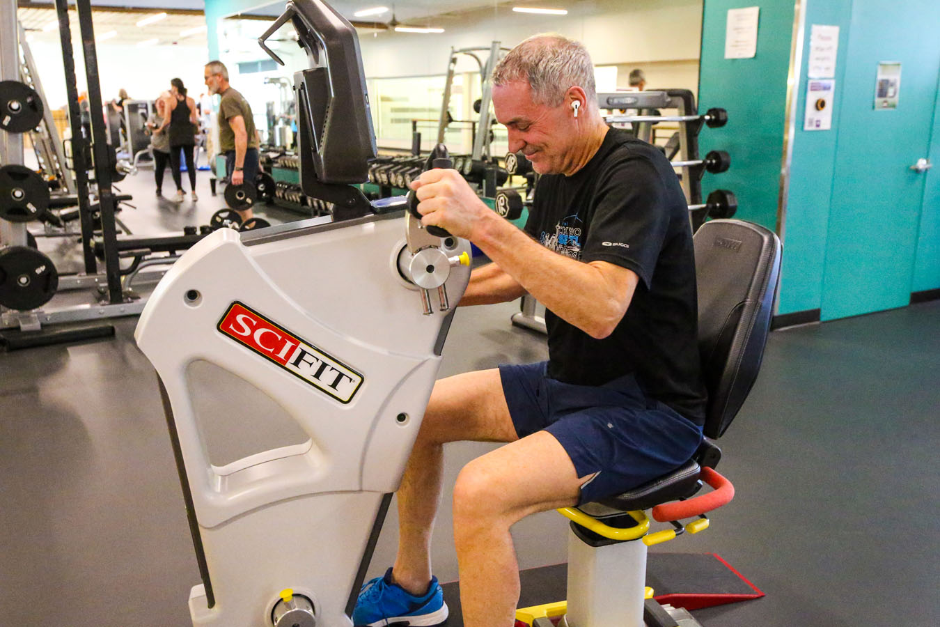 Older adult using a fitness machine at Larkspur.