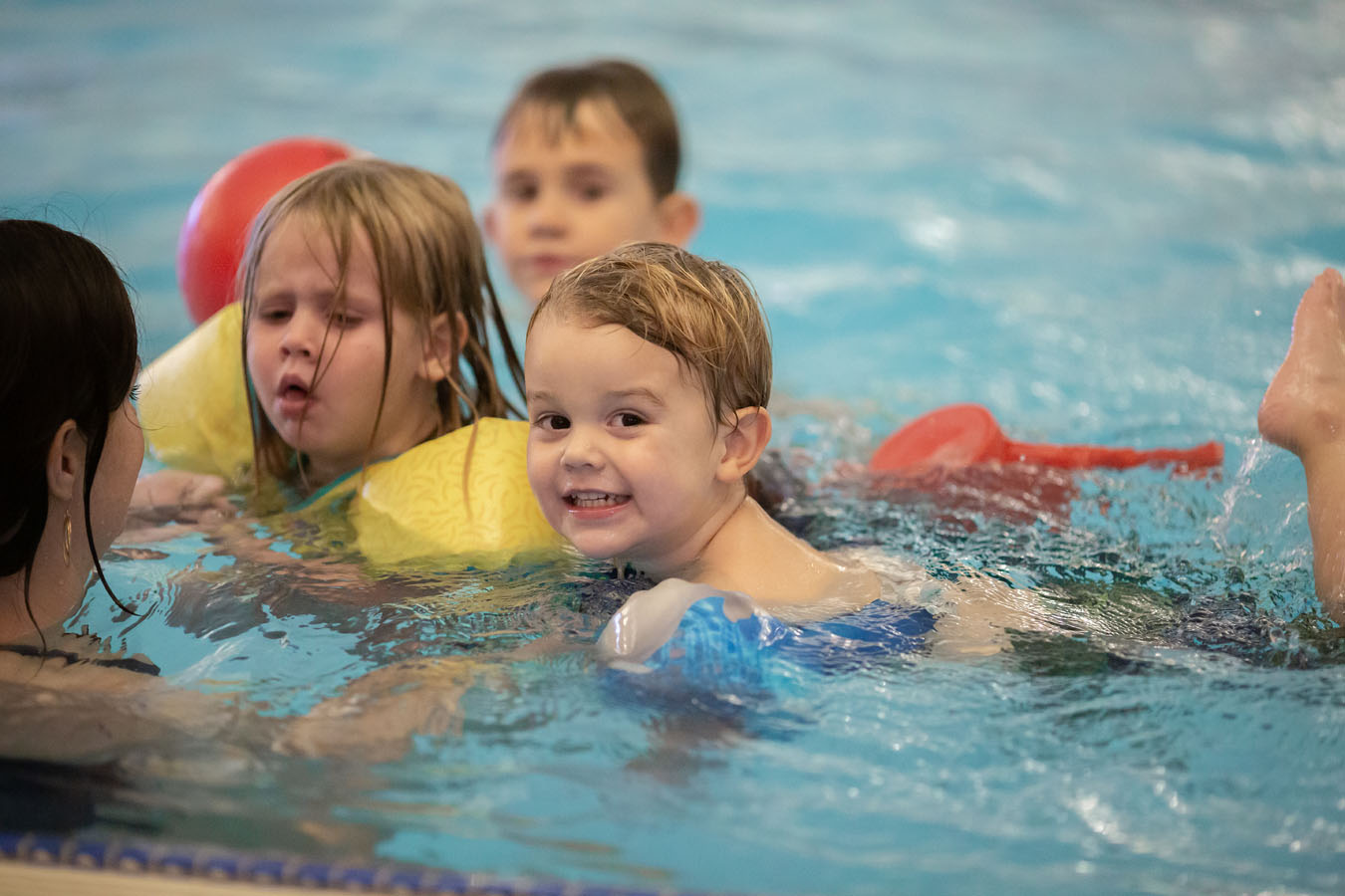 Three young children practice swimming at Larkspur.