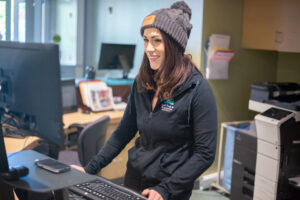 A customer service representative smiling at a Bend Park and Recreation Distrtic Facility