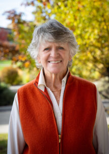 Photograph of Donna Owens looking directly forward with trees in the background.