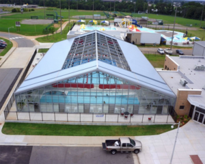 Aerial view of sample pool enclosure structure with retractable panel roof looking down on pool inside