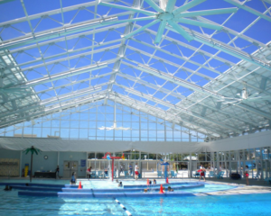 Interier view of sample pool enclosure structure with retractable panel roof looking up from the pool inside